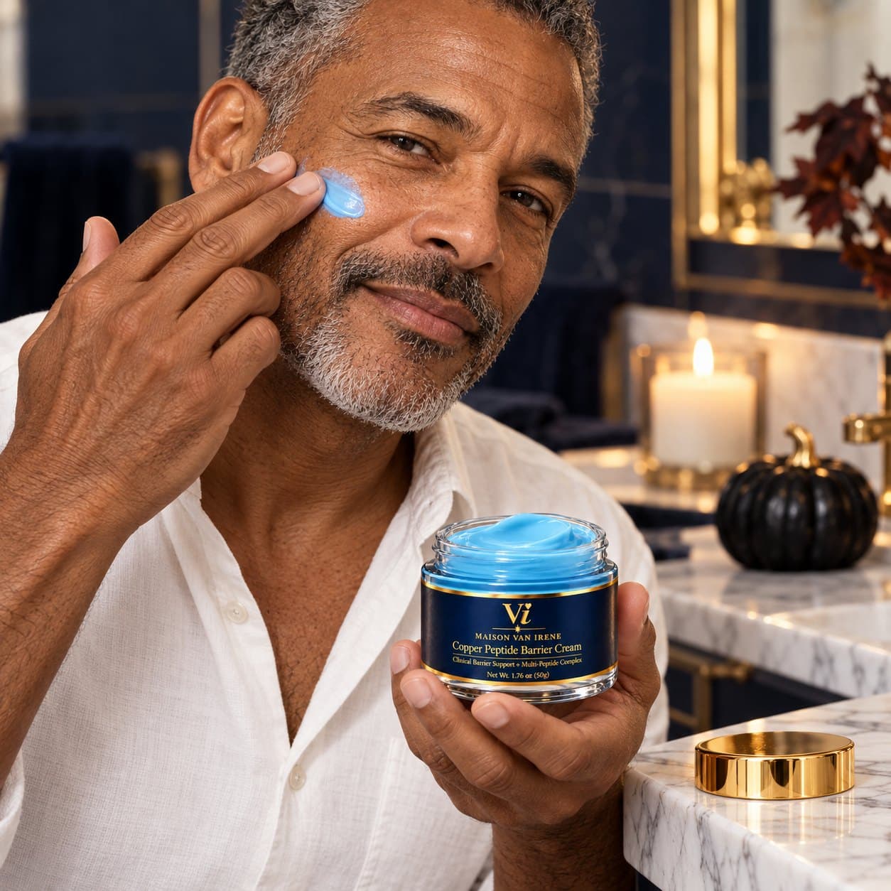 A man applying Copper Peptide Barrier Cream to his cheek, holding the open jar — skincare for men and women
