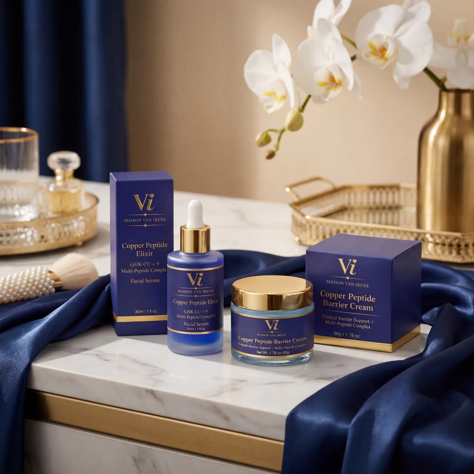 Maison Van Irene Ritual — Copper Peptide Elixir serum and Barrier Cream staged on a marble vanity with navy silk and white orchids